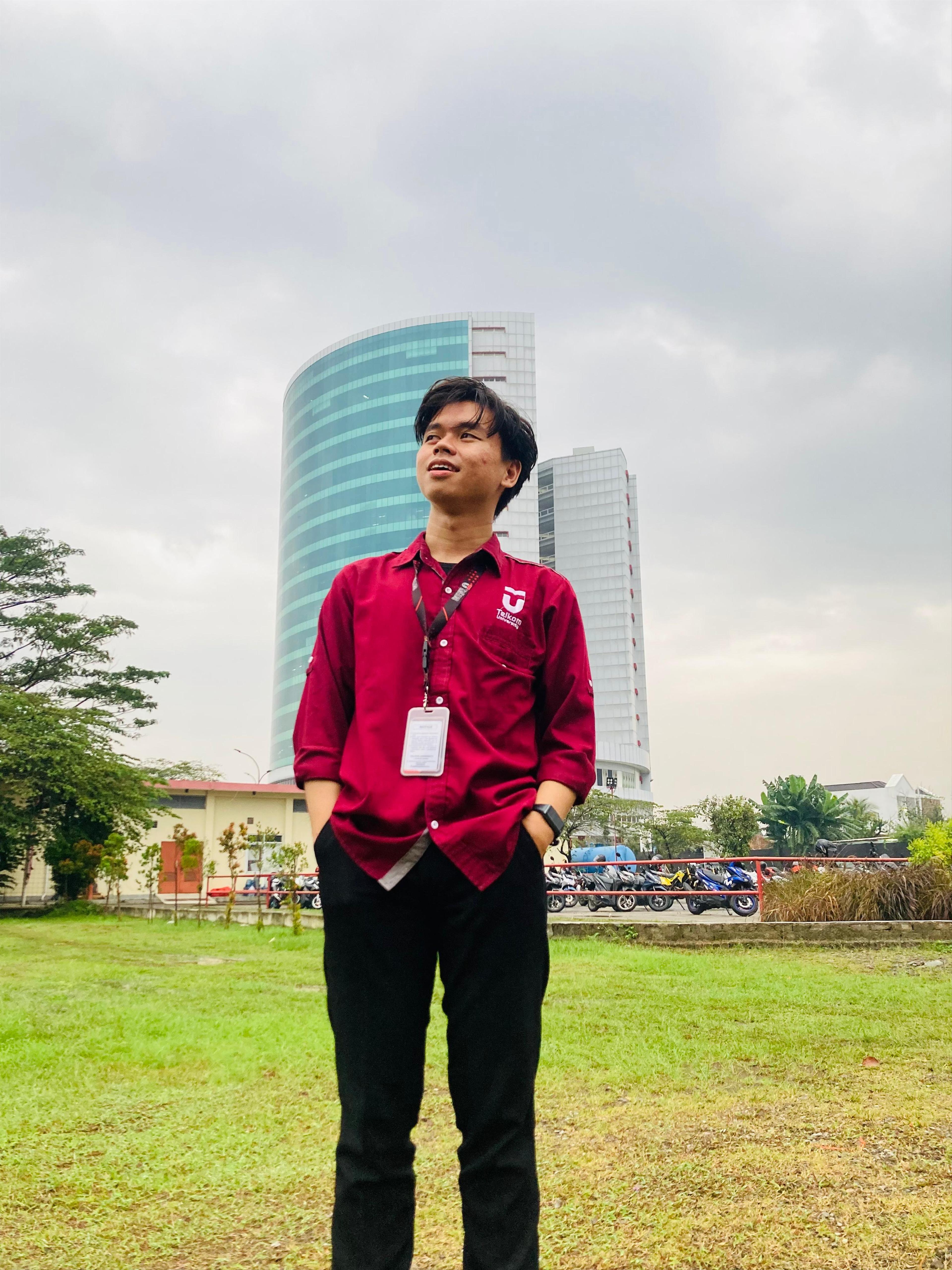 Me standing in front of Telkom University Landmark tower